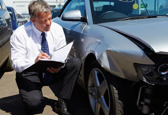 car accident with insurance adjuster assessing damage